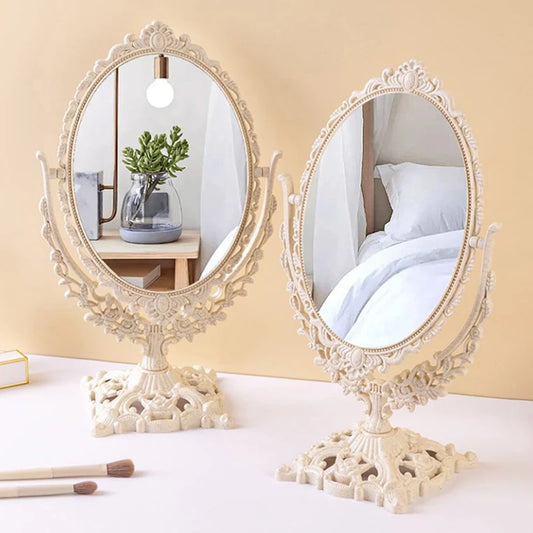 Scandinavian makeup mirror with vintage decorative design, featuring an ornate ivory frame and a sturdy base, perfect for elegant vanity setups.