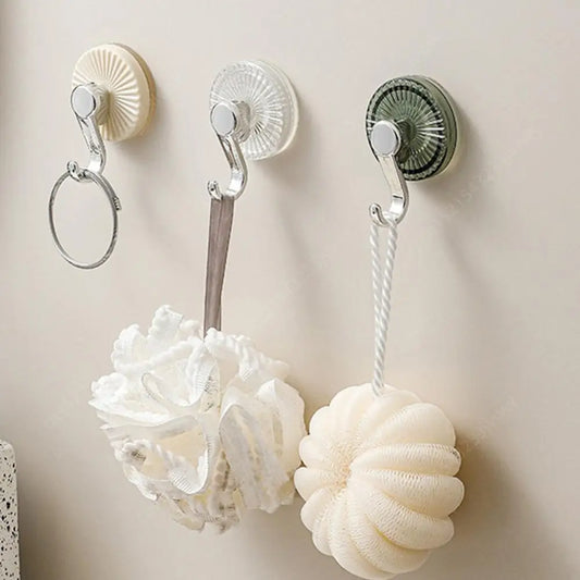 Set of strong vacuum suction cup hooks in various colors, securely holding bath accessories on a smooth wall surface.